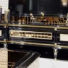 Casa Padrino Luxus Art Deco TV Schrank Schwarz / Weiß / Gold - Massivholz Sideboard mit 3 Schubladen - Art Deco Wohnzimmer Möbel - Luxus Wohnzimmer Möbel - Luxus Art Deco Einrichtung