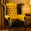 Casa Padrino Luxus Chesterfield Leder Ohrensessel Gelb / Schwarz / Braun H. 110 cm