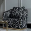 Casa Padrino Luxus Sessel Grau / Schwarz / Gold - Eleganter Wohnzimmer Sessel mit Muster und dekorativem Kissen - Luxus Wohnzimmer Möbel